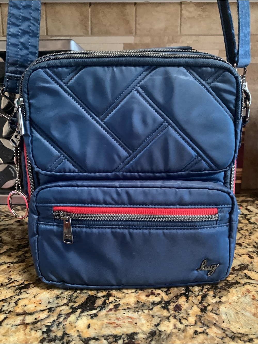 lug Quilted Navy Crossbody Bag with Red Zip Accent